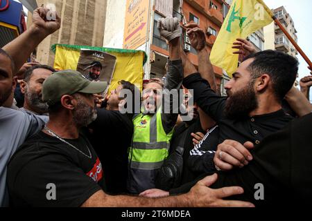 11 November 2023, Lebanon, Beirut: Pro-Iranian Hezbollah fighters chant slogans as they carry the coffin of their colleague, who was killed together with six other comrades during his funeral procession in Beirut's southern suburbs, in one of the party's highest death tolls in a single day Since Hamas made a surprise attack on October 7th, more than 60 Hezbollah fighters have been killed. Photo: Marwan Naamani/dpa Stock Photo