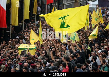 11 November 2023, Lebanon, Beirut: Pro-Iranian Hezbollah fighters chant slogans as they carry the coffin of their colleague, who was killed together with six other comrades during his funeral procession in Beirut's southern suburbs, in one of the party's highest death tolls in a single day. Since Hamas made a surprise attack on October 7th, more than 60 Hezbollah fighters have been killed. Photo: Marwan Naamani/dpa Stock Photo