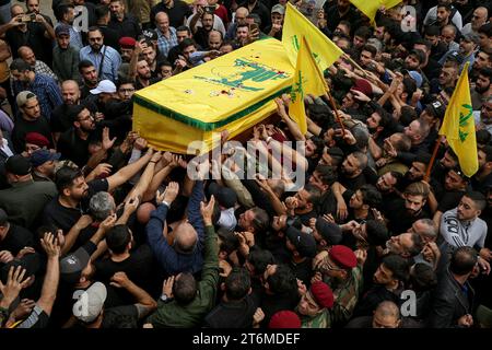 11 November 2023, Lebanon, Beirut: Pro-Iranian Hezbollah fighters chant slogans as they carry the coffin of their colleague, who was killed together with six other comrades during his funeral procession in Beirut's southern suburbs, in one of the party's highest death tolls in a single day. Since Hamas made a surprise attack on October 7th, more than 60 Hezbollah fighters have been killed. Photo: Marwan Naamani/dpa Stock Photo