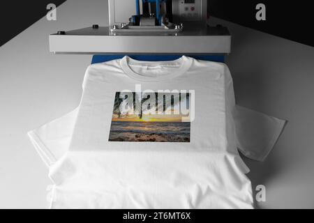 TShirt Print Using Heat Press Machine. Shirt Printing Stock Photo