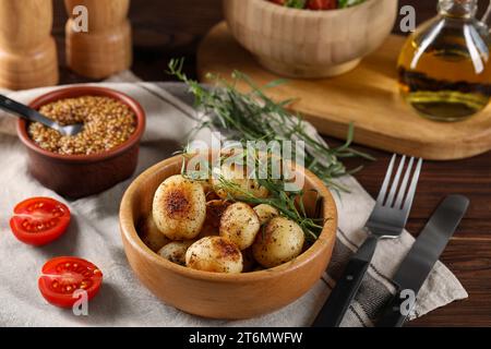 Delicious grilled potatoes with tarragon and mustard on wooden table Stock Photo