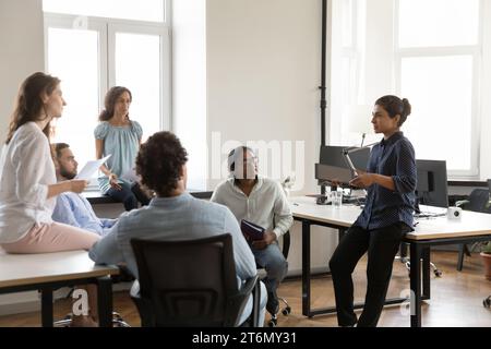 Diverse business group of serious employees negotiating on work project Stock Photo