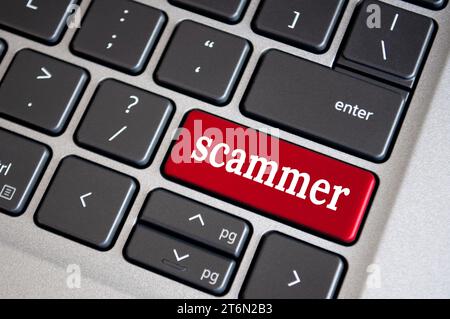 Scammer text on red color keyboard. Security and cyber attach concept. Stock Photo