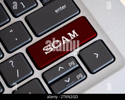 Scam text on red color keyboard. Online security concept. Stock Photo