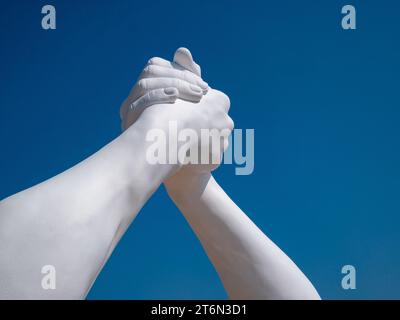 Vieste, Italy - 25 August 2023:View of Building Bridges, six pairs of giant hands, 15 meters high and joined, in the heart of Vieste on the Marina Pic Stock Photo