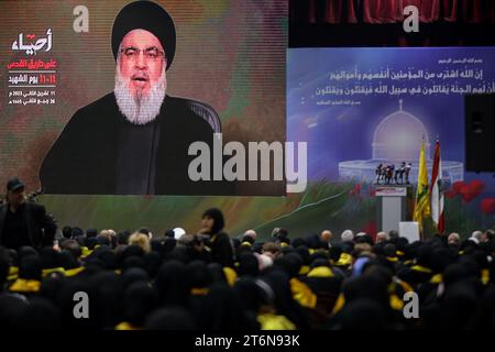 11 November 2023, Lebanon, Beirut: Supporters of the Lebanese Shiite Muslim movement Hezbollah, watch the movement's chief Hassan Nasrallah deliver an address on a large screen to mark the Martyrs' Day, amid the ongoing battles between Israel and the Palestinian group Hamas. Photo: Marwan Naamani/dpa Stock Photo