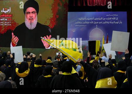 11 November 2023, Lebanon, Beirut: Supporters of the Lebanese Shiite Muslim movement Hezbollah, watch the movement's chief Hassan Nasrallah deliver an address on a large screen to mark the Martyrs' Day, amid the ongoing battles between Israel and the Palestinian group Hamas. Photo: Marwan Naamani/dpa Stock Photo