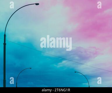 Minimalist background painted with pastel colored gradient. Street lights and cloudy sky Stock Photo