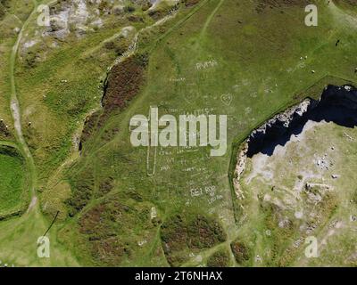 Aerial view of a crucifix and other messages and motifs laid out in stone by the Great Orme quarry, Wales UK Stock Photo