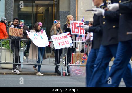 New York City, United States. 11th November, 2023. Spectators holding 'Thank You' signs in the Annual Veterans Day Parade along 5th Avenue in New York City. Credit: Ryan Rahman/Alamy Live News Stock Photo