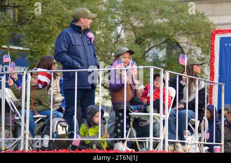 New York City, United States. 11th November, 2023. Young marchers are seen holding the UNited States flag in the Annual Veterans Day Parade along 5th Avenue in New York City. Credit: Ryan Rahman/Alamy Live News Stock Photo