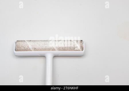 Sticky adhesive roller head for catching fur to clean floors. It is full of fur and hair of many types. It can also catch other dirt such as dust, deb Stock Photo