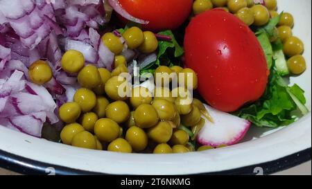 green salad with red onion and peas, food vegetables lunch breakfast, tomato Stock Photo