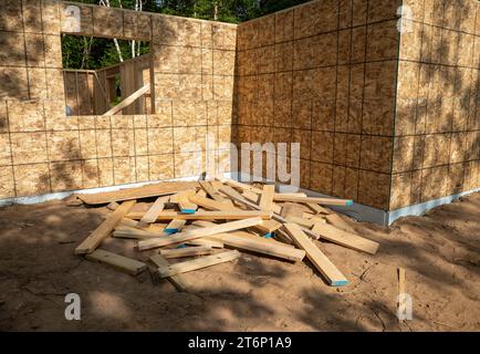 A pile of cut wood board leftover scraps, left in a heap at a constuction site. Stock Photo