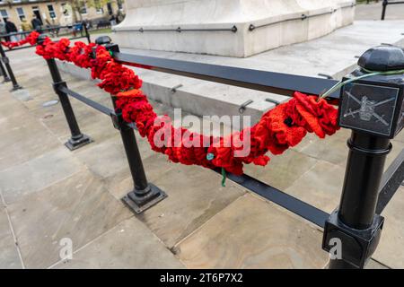 Newcastle upon Tyne, UK. 11th November 2023. Armistice Day. Crochet poppies attached to railings at the war memorial at Old Eldon Square in the city. Credit: Hazel Plater/Alamy Live News Stock Photo