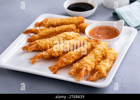 Cooked tempura shrimp on a plate with dipping sauce freshly made and ready to eat Stock Photo
