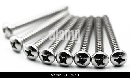 Wood screws arranged on white background close up Stock Photo