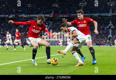 (231112) -- MANCHESTER, Nov. 12, 2023 (Xinhua) -- Luton Town's Andros Townsend (C) is challenged by Manchester United's Victor Lindelof (L) and Harry Maguire (R) during the English Premier League match between Manchester United FC and Luton Town FC in Manchester, Britain, on Nov. 11, 2023. (Xinhua) FOR EDITORIAL USE ONLY. NOT FOR SALE FOR MARKETING OR ADVERTISING CAMPAIGNS. NO USE WITH UNAUTHORIZED AUDIO, VIDEO, DATA, FIXTURE LISTS, CLUB/LEAGUE LOGOS OR 'LIVE' SERVICES. ONLINE IN-MATCH USE LIMITED TO 45 IMAGES, NO VIDEO EMULATION. NO USE IN BETTING, GAMES OR SINGLE CLUB/LEAGUE/PLAYER PUBLICATI Stock Photo