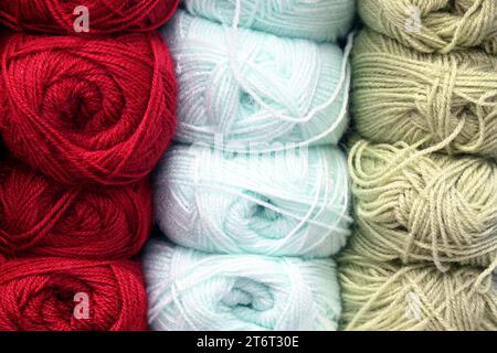 Colourful yarn balls organized in rows for knitting projects in haberdashery shop Stock Photo