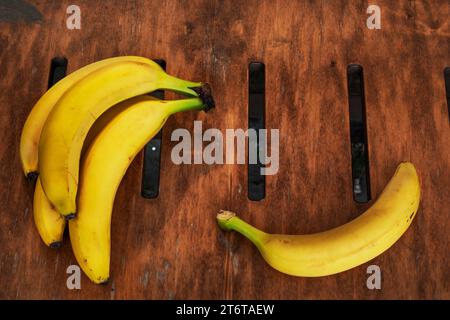 bunch of ripe yellow banana on a wooden surface. view from above Stock Photo