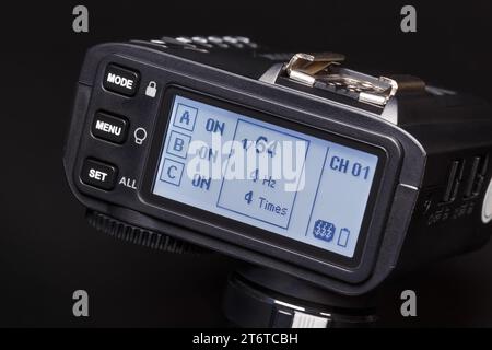 Modern wireless synchronizer with display, close-up on a dark background. Equipment for photography. Stock Photo