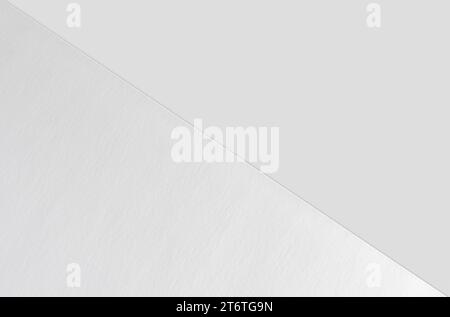 Close-up of empty white poster mockup lying diagonally with soft shadow on neutral light grey background. Flat lay, top view. Open composition. Stock Photo