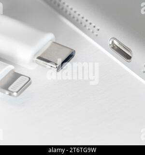 View of apple device with both usb-c and lightning cable charger. Eu forced Apple iphone to Use usb-c instead of lighting cable. Stock Photo