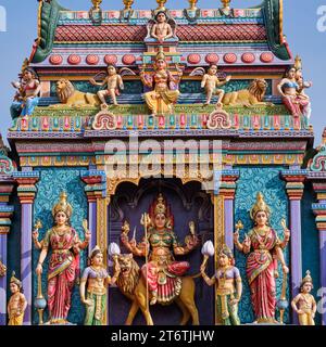 The top of the gopuram (entrance tower) of Sri Vadapathira Kaliammam Temple, with colorful figures of Hindu deities; Little India, Singapore Stock Photo