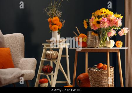 Room decorated with pumpkins and bright flowers. Autumn vibes Stock Photo