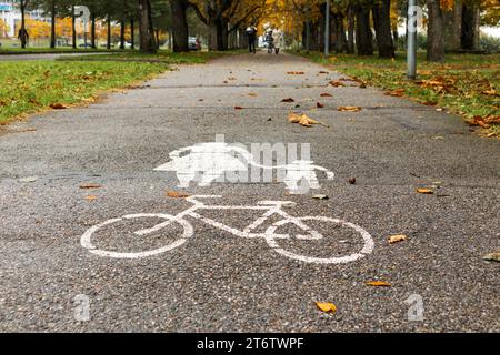 Pedestrian and bicycle path sign on gray asphalt directed with perspective view Stock Photo