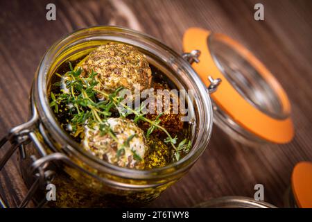 LABNEH CHEESE BOLLS WITH DRY MINT, BLACK AND WHITE SESAME, SUMAC AND ZAATAR IN A JAR WITH OLIVE OIL Stock Photo