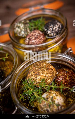 LABNEH CHEESE BOLLS WITH DRY MINT, BLACK AND WHITE SESAME, SUMAC AND ZAATAR IN A JAR WITH OLIVE OIL Stock Photo