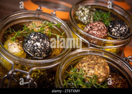 LABNEH CHEESE BOLLS WITH DRY MINT, BLACK AND WHITE SESAME, SUMAC AND ZAATAR IN A JAR WITH OLIVE OIL Stock Photo