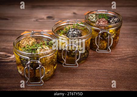 LABNEH CHEESE BOLLS WITH DRY MINT, BLACK AND WHITE SESAME, SUMAC AND ZAATAR IN A JAR WITH OLIVE OIL Stock Photo