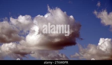 Blue sky with gloomy black clouds and sun rays Stock Photo