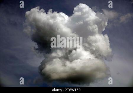 Blue sky with gloomy black clouds and sun rays Stock Photo