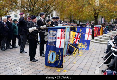 Standards are lowered by standard bearers as the Last Post is played ahead of a two minute silence during a Remembrance Sunday service in Guildhall Square, Portsmouth. Picture date: Sunday November 12, 2023. Stock Photo