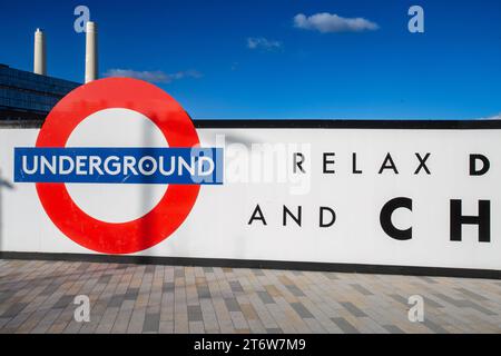 Battersea power station underground station in London, with Battersea Power Station in background Stock Photo