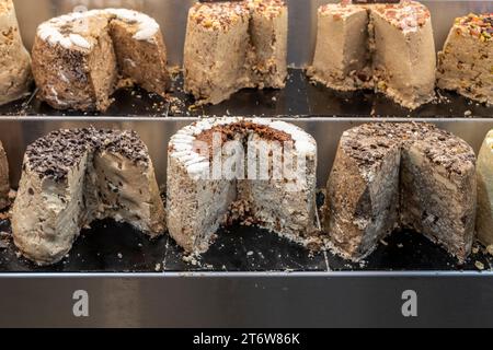 A selection of specially-flavored halva or sesame candy cakes, a Middle Eastern treat, on sale in Jerusalem's Machane Yehuda market. Stock Photo