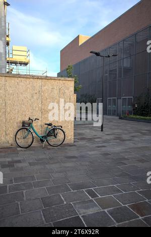Bike  leaning on a lawn in a small square of an italian town Stock Photo