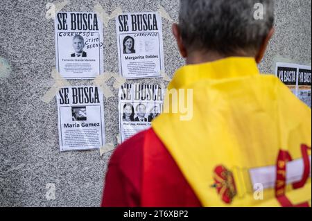 Madrid, Spain. 12th Nov, 2023. A man looks at placards glued to the wall during a protest called by far right party VOX against the amnesty deal for Catalan separatists. Demonstrators have gathered near socialista party PSOE headquarters to protest against the government of Pedro Sanchez and the approval of an amnesty for Catalan separatist leaders which is included in the agreement that guarantees the investiture of the socialist candidate. Credit: Marcos del Mazo/Alamy Live News Stock Photo