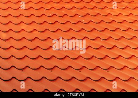 Orange metallic roof tile pattern as background, selective focus Stock Photo