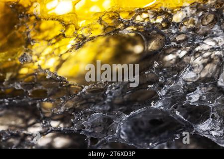 Texture of homemade slice of sourdough freshly baked bread background, activated carbon baguette, pumpkin and turmeric spice Stock Photo