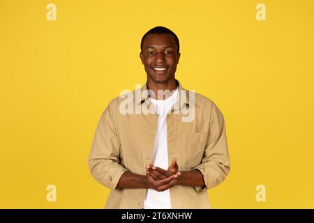 Positive young handsome black man student, teacher in casual, look at camera Stock Photo