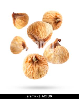 Many dried figs falling on white background Stock Photo