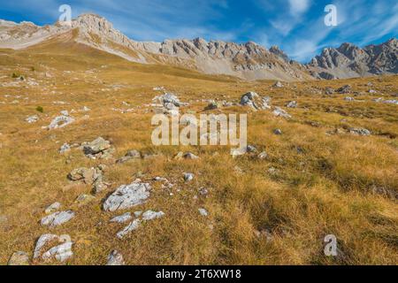 Mountain ridge in the San Pellegrino Pass area, steep rocky crest towering above grassy slopes in a fall day. Stock Photo