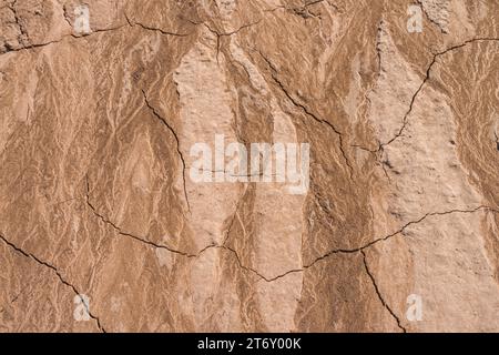 Severe drought producing parched dry ground, with cracked dry mud and artistic shapes in the sandy earth. Climate change in the mountains. Stock Photo