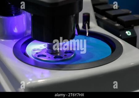 Automatic grinding and polishing machine close up. Laboratory equipment for sample preparation. Selective focus. Stock Photo