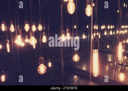 Vintage light bulbs hanging on the ceiling, retro color tone. Stock Photo