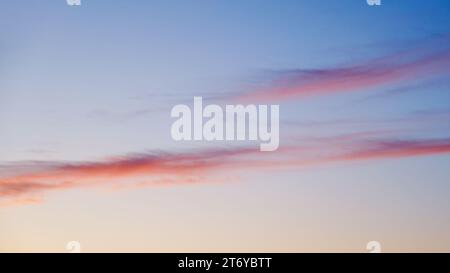 The pink and blue hues of the evening sky were reflected in the clouds, creating a dreamy and romantic atmosphere. Stock Photo